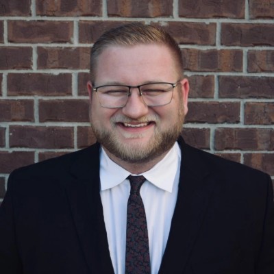 Colton, founder of TreeOperator, wearing a suit and tie